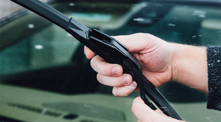 Image of a person holding a wiper blade in their hand